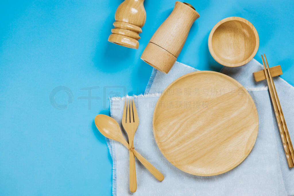 Kitchenware set with with tablecloth on blue background