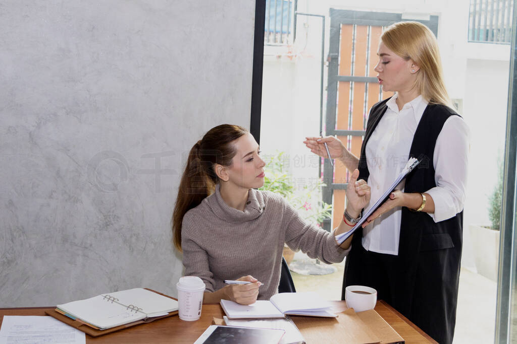 Two women are studying and teaching