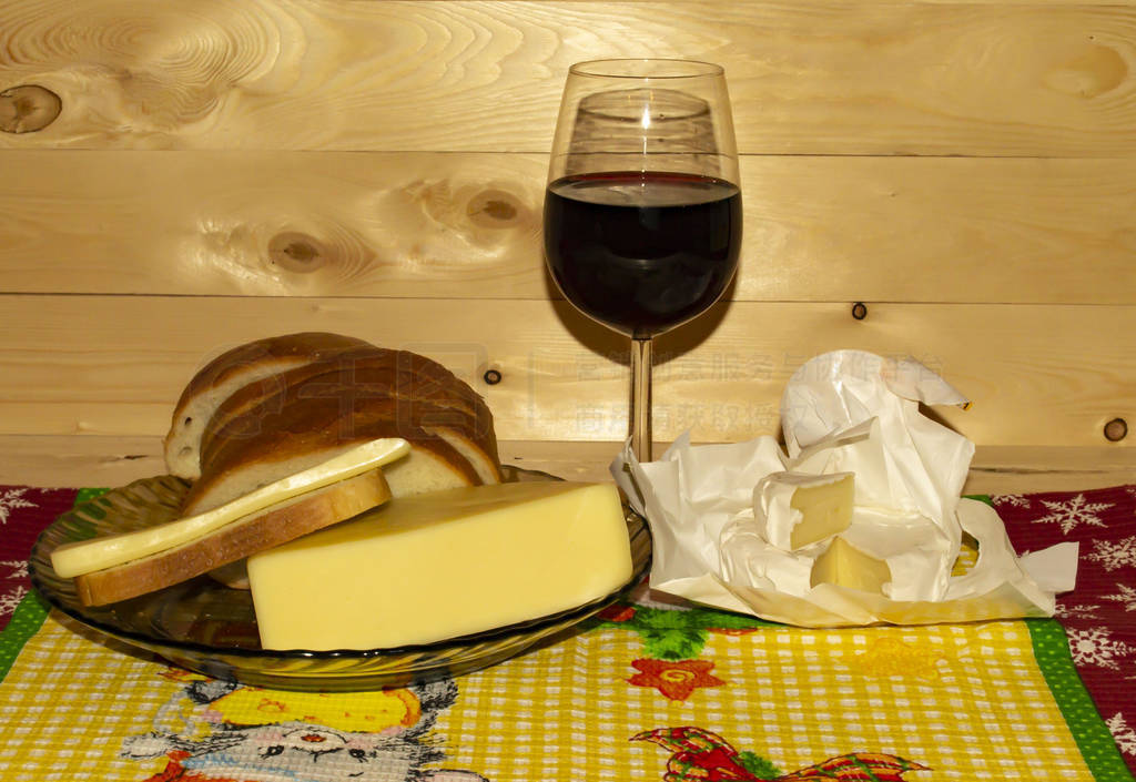 Tasty snacks, glass of wine and Camembert