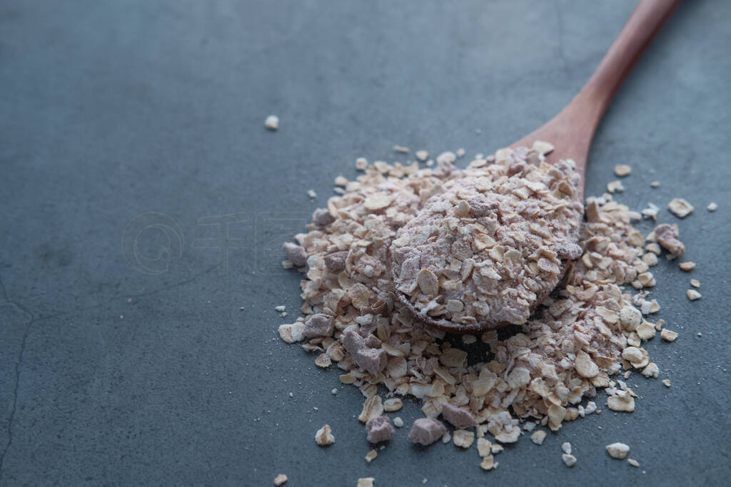 Close up of oat on spoon on color background