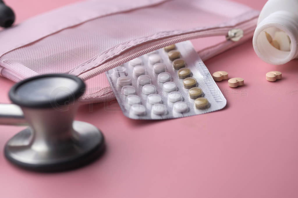 Close up of birth control pills and stethoscope on table