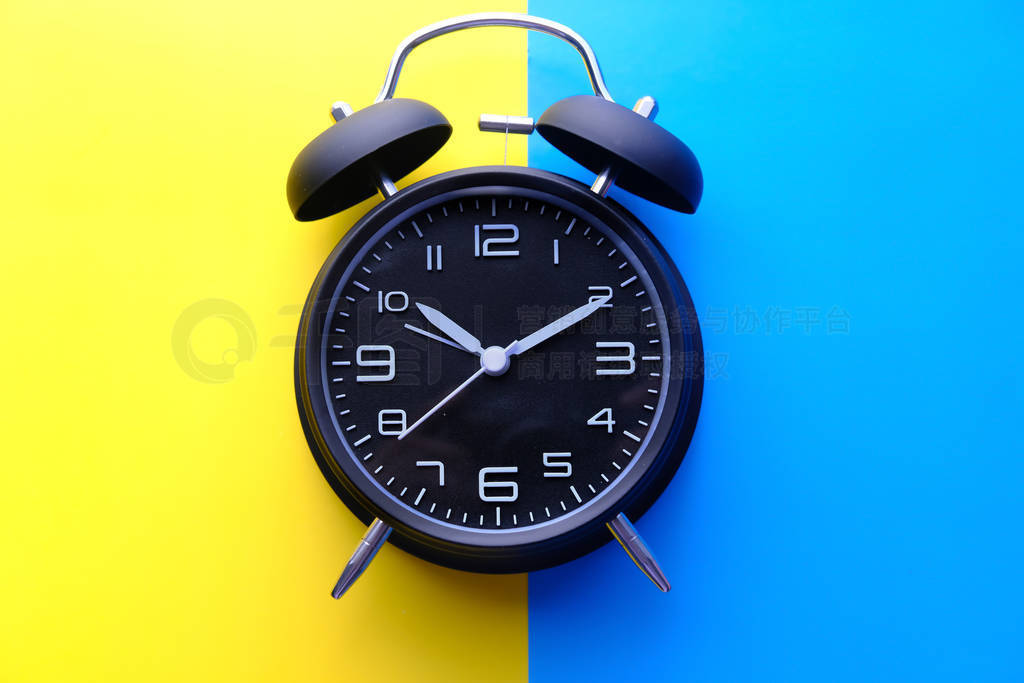 top view of alarm clock on color background