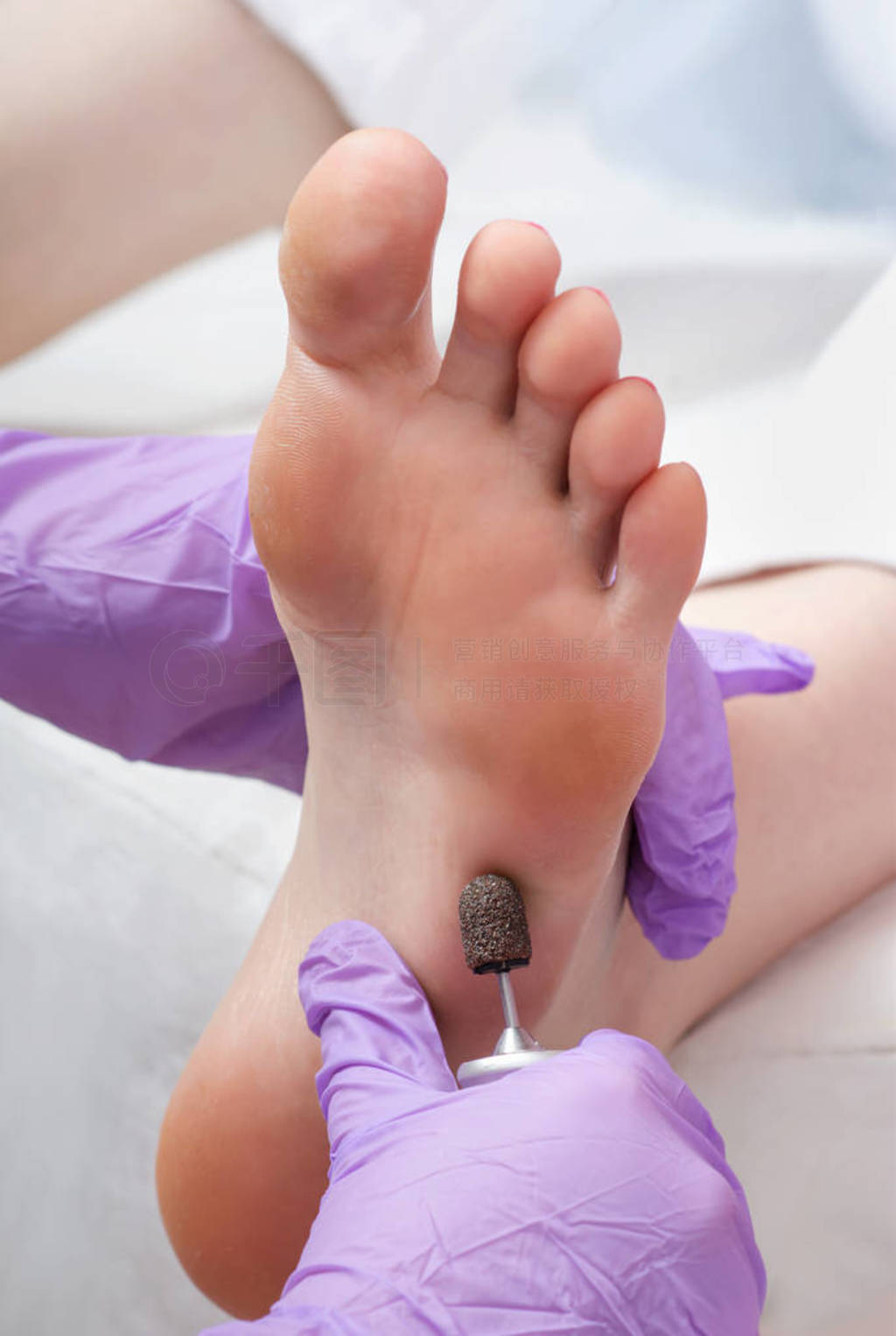 Peeling feet pedicure procedure with eletric device in the beau