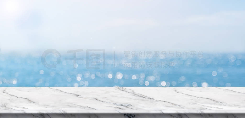 Empty white marble table top with blur blue sky and sea boekh ba