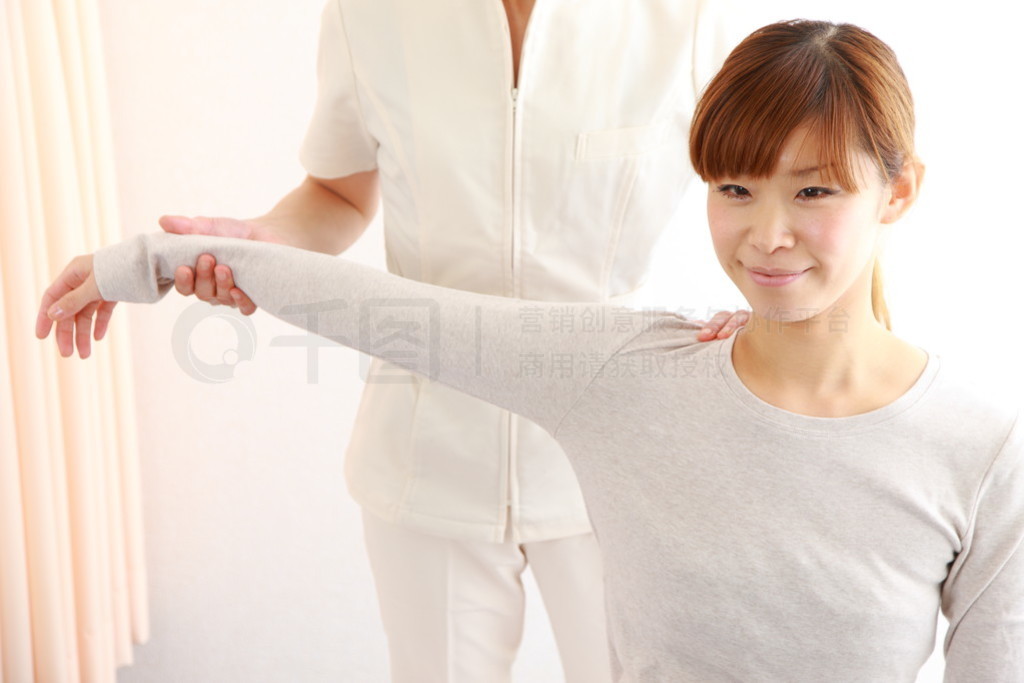 Young Japanese woman getting chiropractic