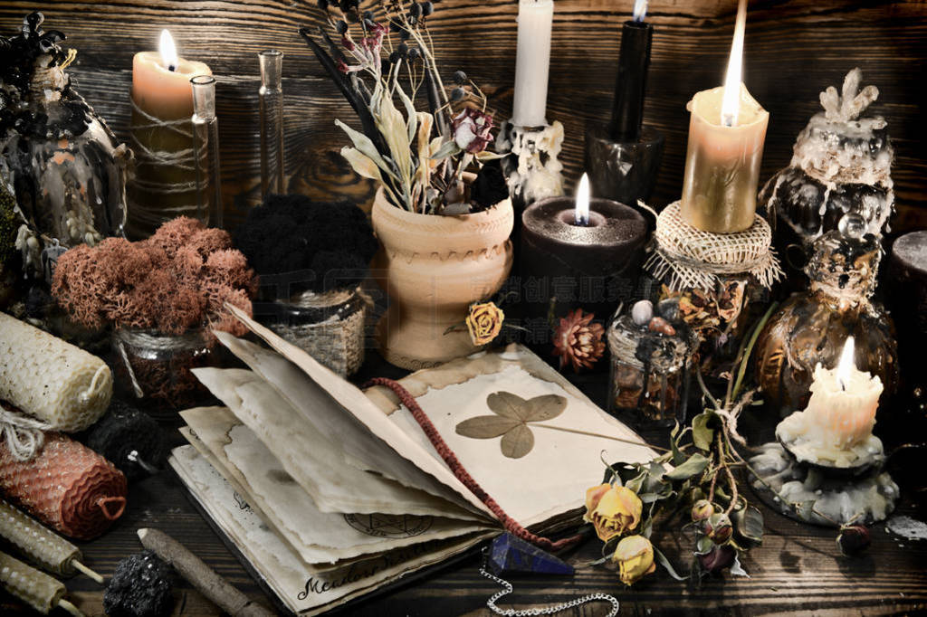 Witch table with magic objects, four-leaf clover, candles and op