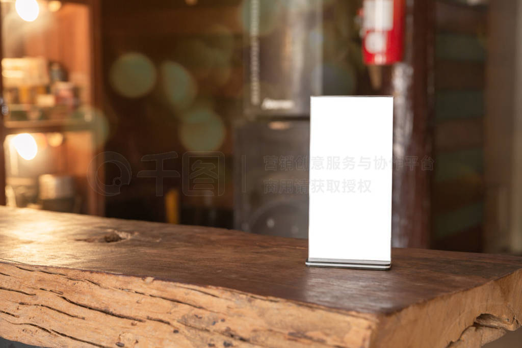 Mock up Menu frame standing on wood table in coffee shop.