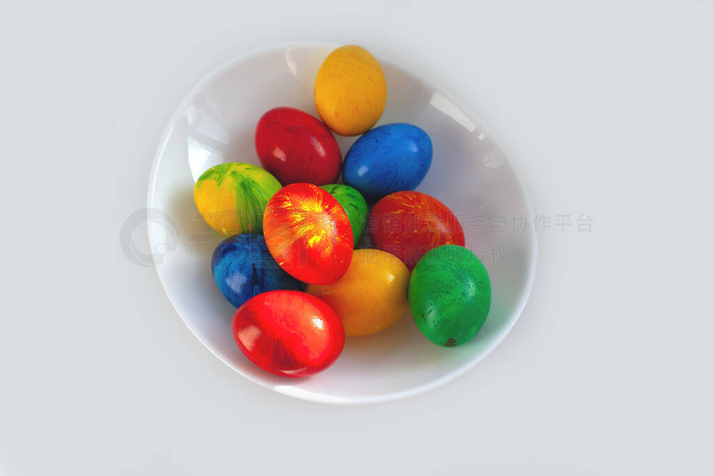 Colorful eggs on a white plate. Shadow. On isolated background.