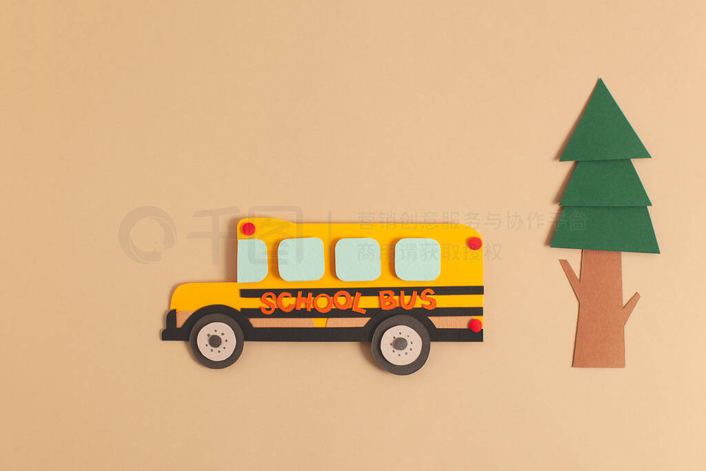 Back to school concept. Yellow bus with tree. Paper cutout artwo