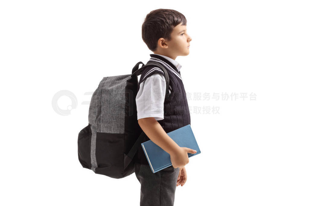 Profile view of a schoolboy in a uniform and a backpack