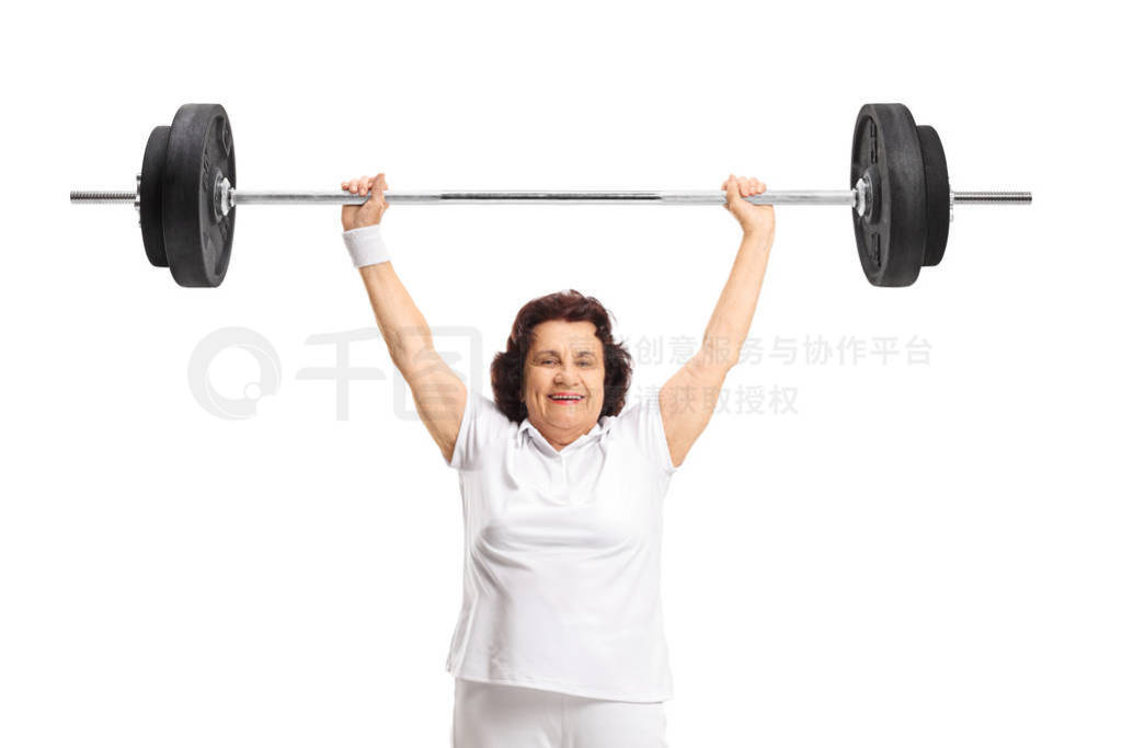 Strong elderly woman lifting a barbell
