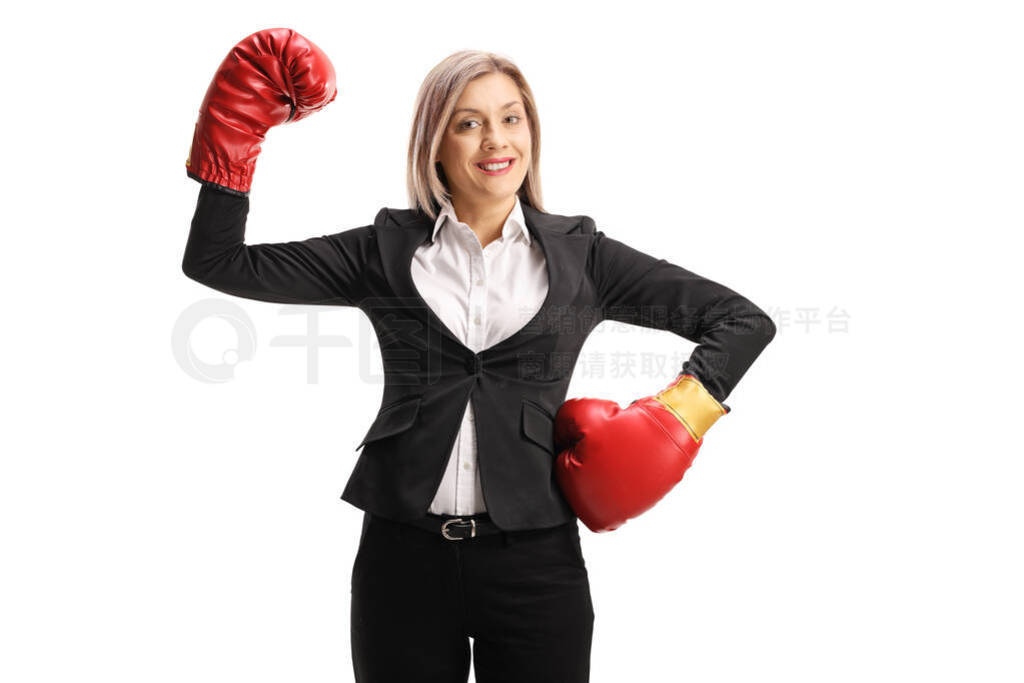 Successful businesswoman with boxing gloves raising hand like a