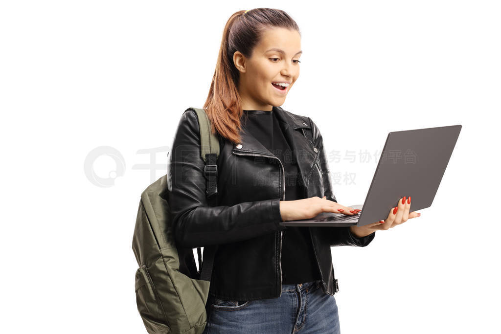 Happy female student loking at a laptop computer