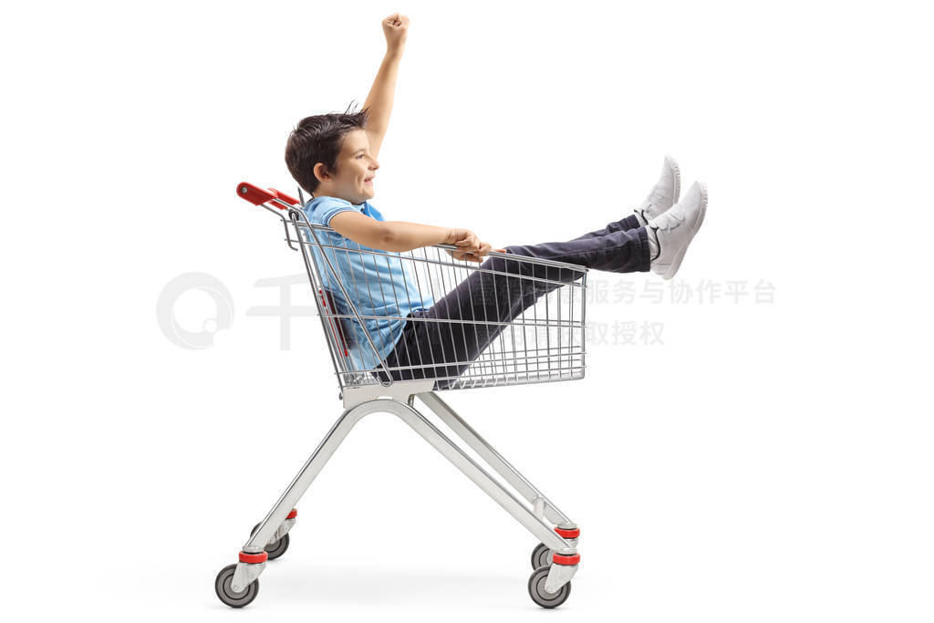 Playful child inside a shopping cart gesturing with hand