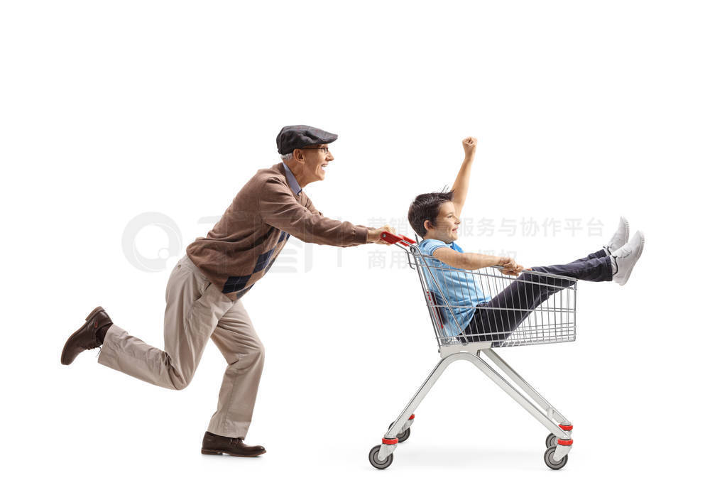 Grandfather pushing a shopping cart with a boy inside