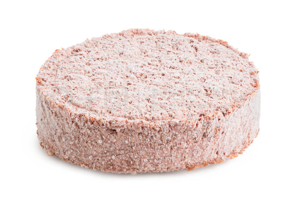 Frozen plant based burger patty isolated on white.