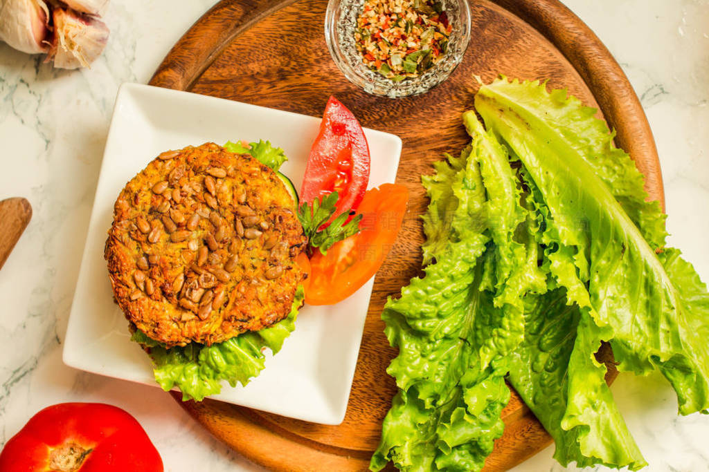 Baked vegan burgers with beans and seeds, vegetables and herbs.