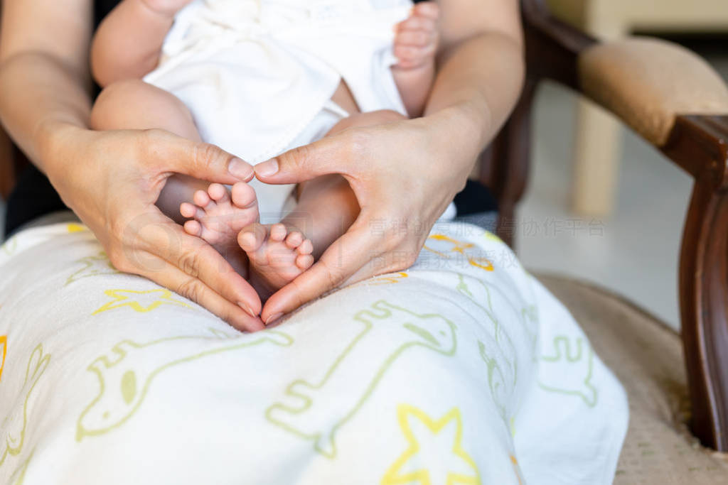 s feet on Mothers hand in heart shaped, Family and Love concept