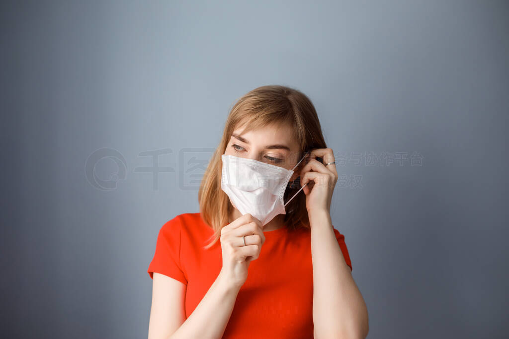 Good-looking woman puts on medical mask to protect her health. S