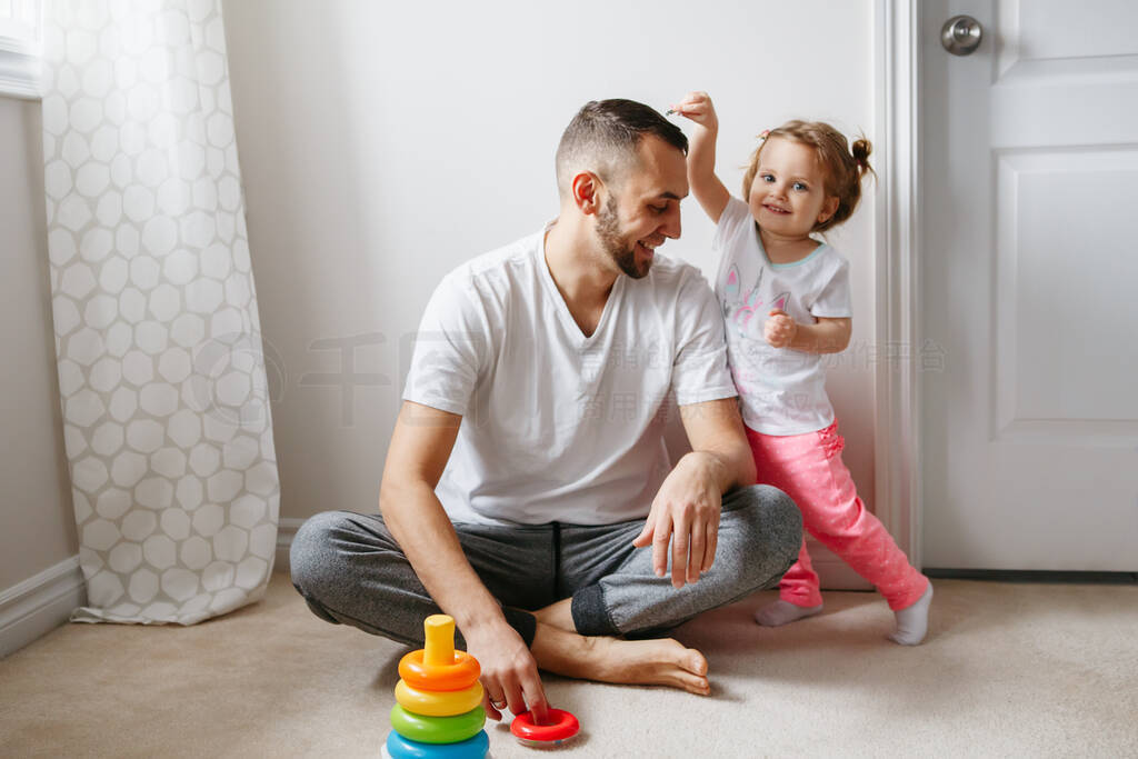 Young Caucasian father playing with child girl. Male man parent