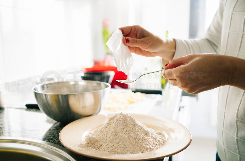 Woman prepares the ingredients to make a sponge cake