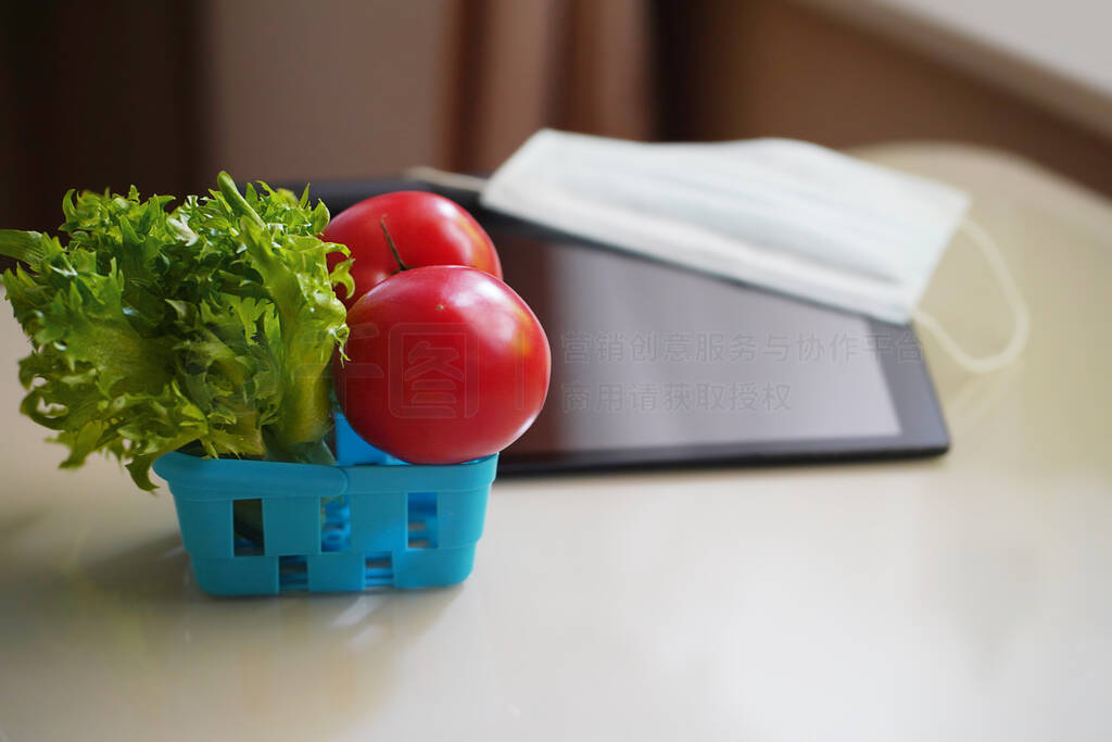 Defocused Shopping online, laptop and a shopping basket