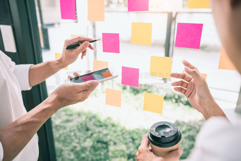 Business people meeting at office and use sticky notes on glass