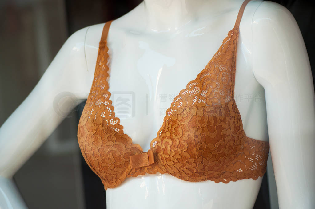 closeup of orange bra on mannequin in fashion store showroom