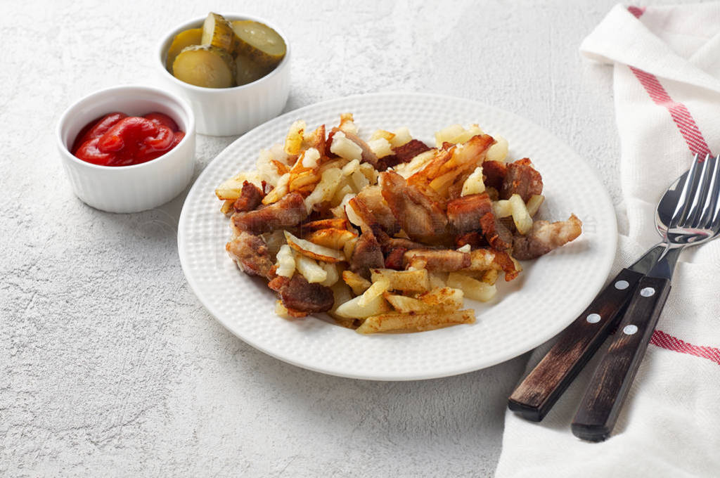 Crispy pan fried potatoes with pork, pickles and tomato ketchup