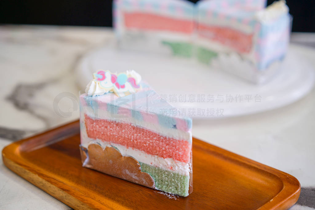 rainbow cake on wooden plate