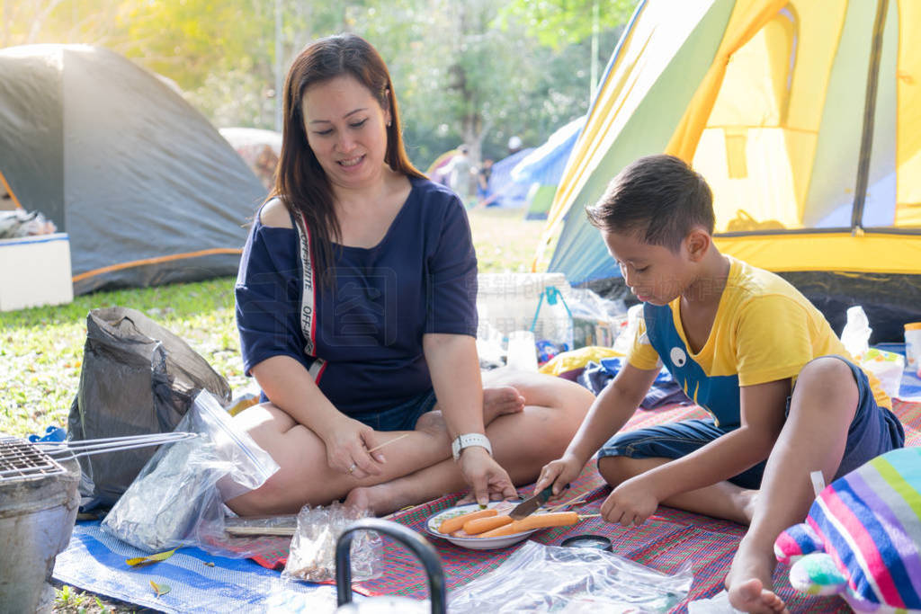 Mom and Son camping in forest.