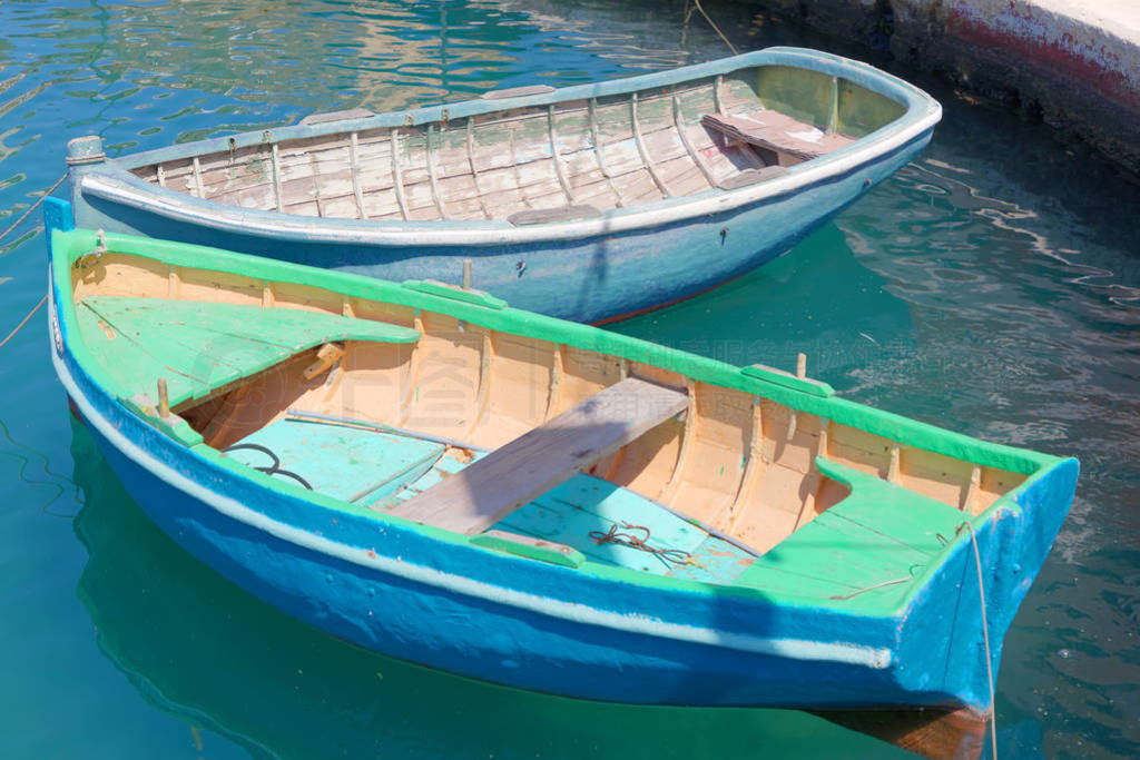 Colorful blue and green traditional fishing boats in the harbor