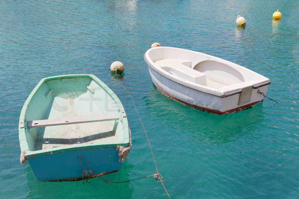 Colorful blue and green traditional fishing boats in the harbor