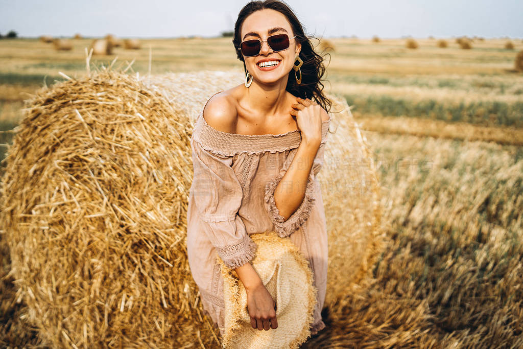 Smiling woman in sunglasses with bare shoulders on a background