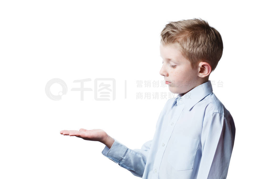 small boy shows on palms, portrait of schoolboy
