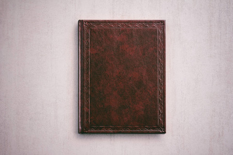 这本书在一个红色的封面上浅灰色的背景，顶视图