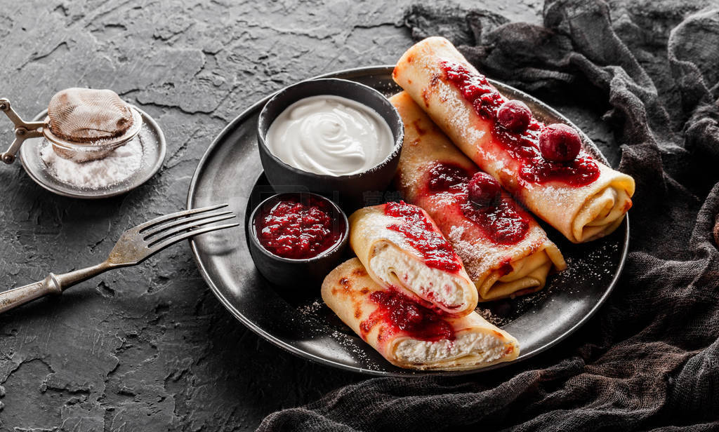 Crepes with cottage cheese, fruit jam, cherries, sour cream and