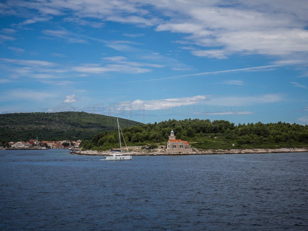 Ferry passing close to Sucuraj lighthouse on Hvar island, Croati