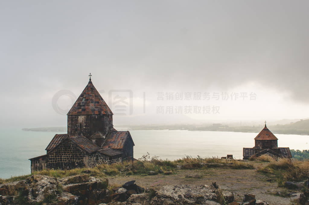 Old Sevanavanq monastery while rainy weather in Sevan Armenia