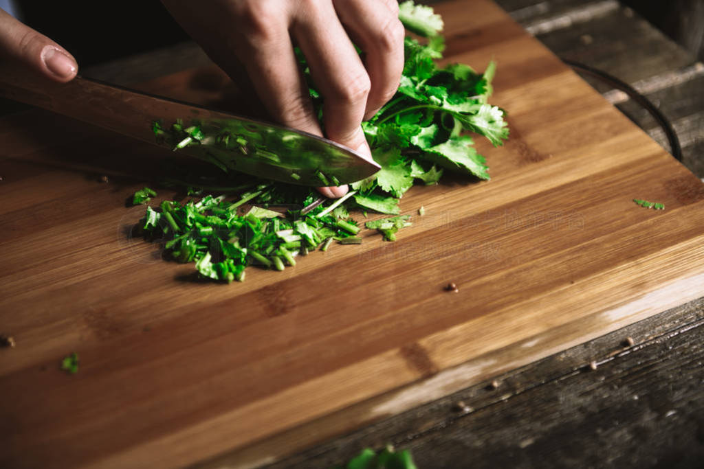 close up hands cutting green parsley