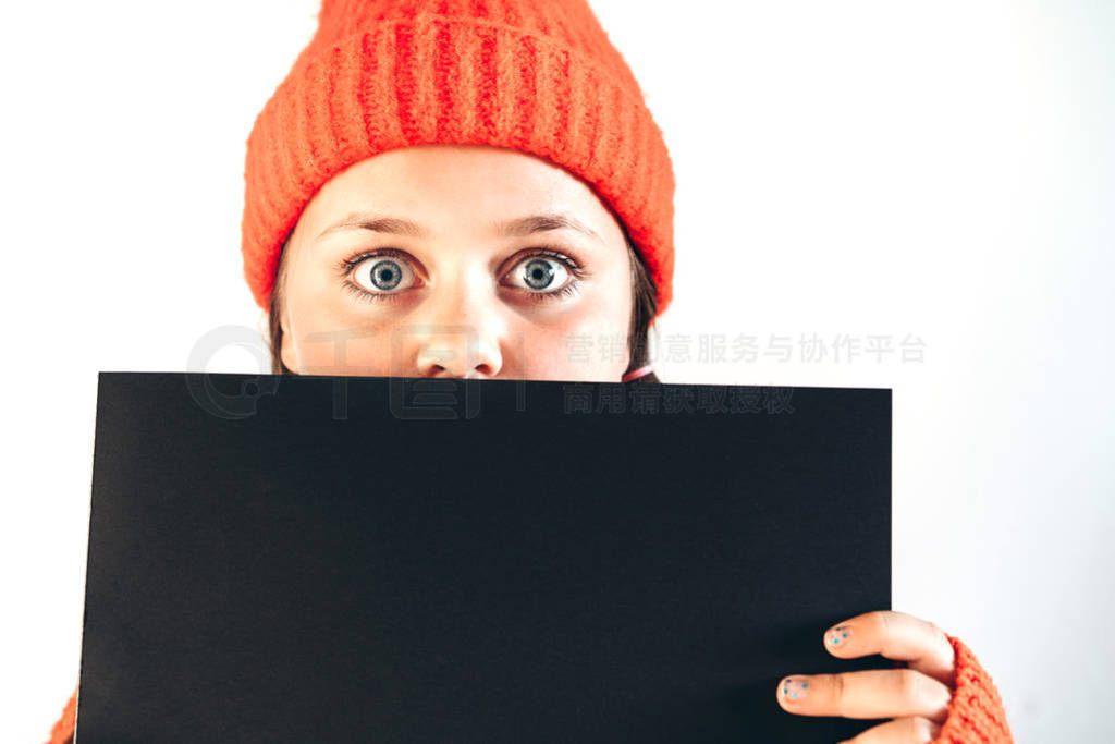 A beautiful girl in a red hat with large wide open eyes