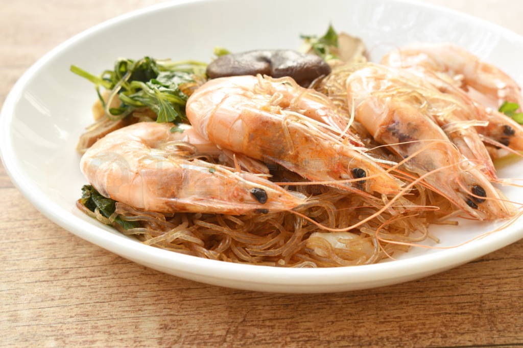 shrimp steamed with glass noodle and ginger on white plate