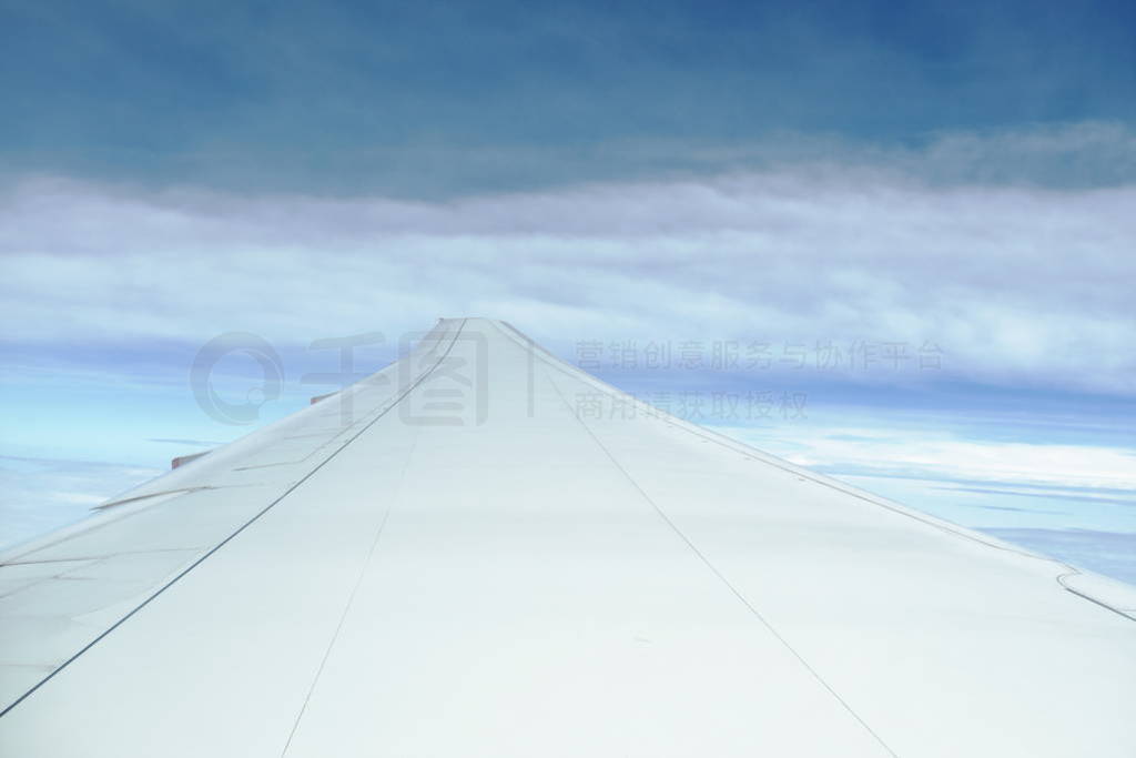 plane wing and cloud floating on sky through window frame