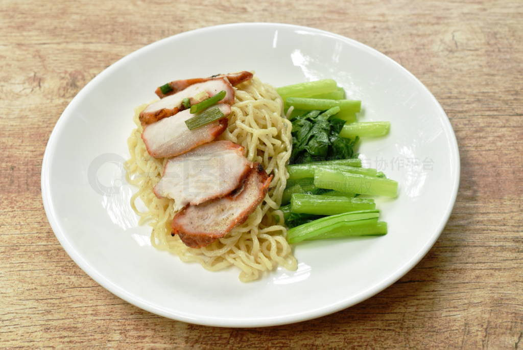 Chinese egg noodles topping slice roasted pork on plate