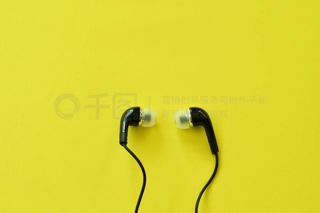black earphone for conecting with mobile phon arranging on yell