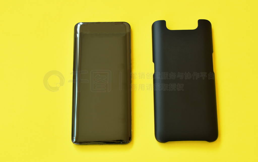 mobile phone with black case arranging on yellow background