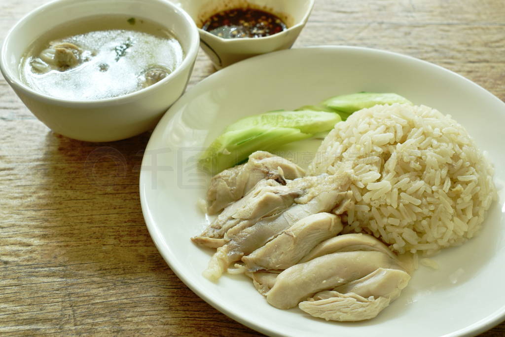 steamed rice topping boiled chicken with sauce and soup