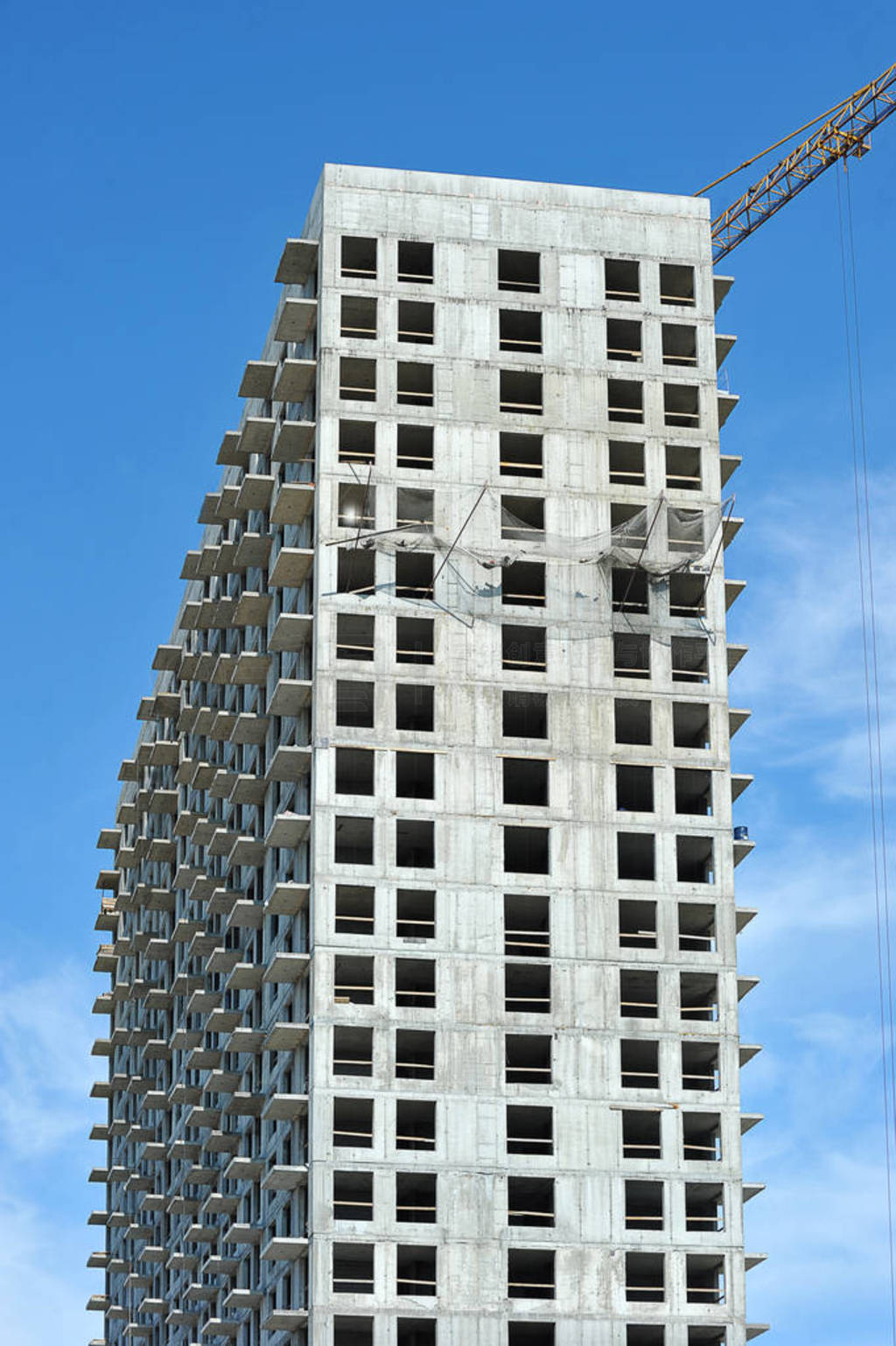 empty concrete box of high-rise building and construction crane