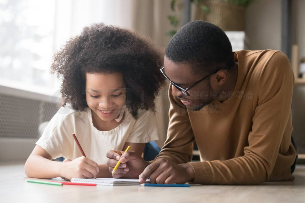 Caring black dad drawing with colored pencils teaching child gir