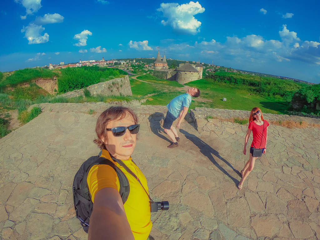 Tourists take a selfie. The old castle of Kamyanets-Podilsky is
